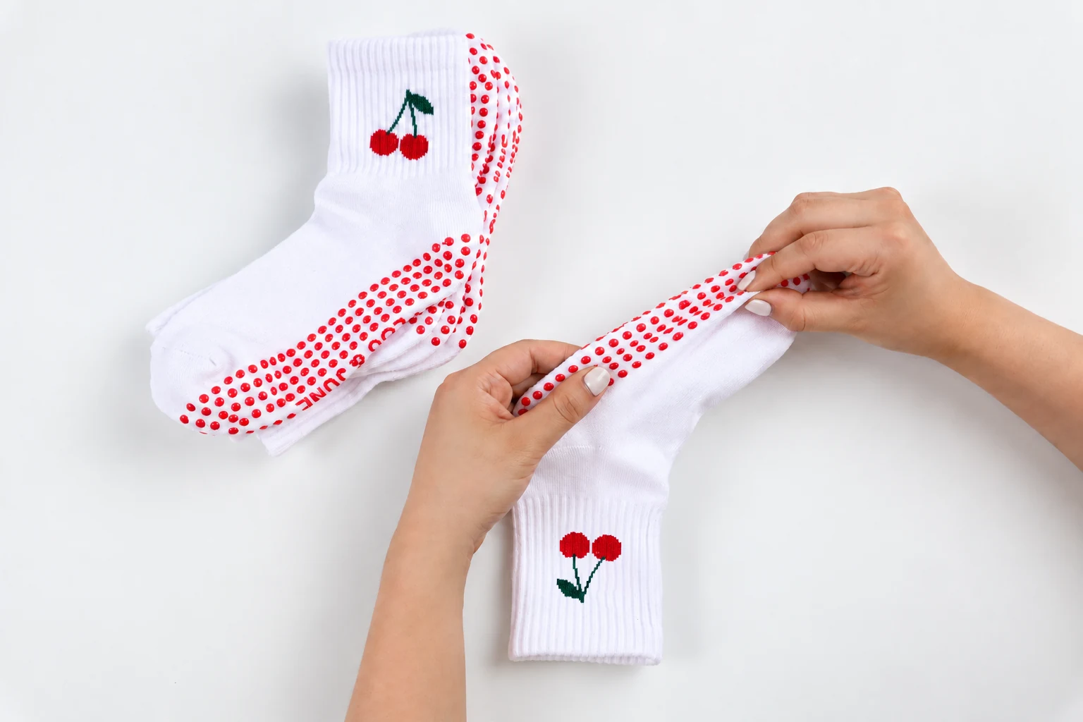 Hands checking the grip placement on a sock