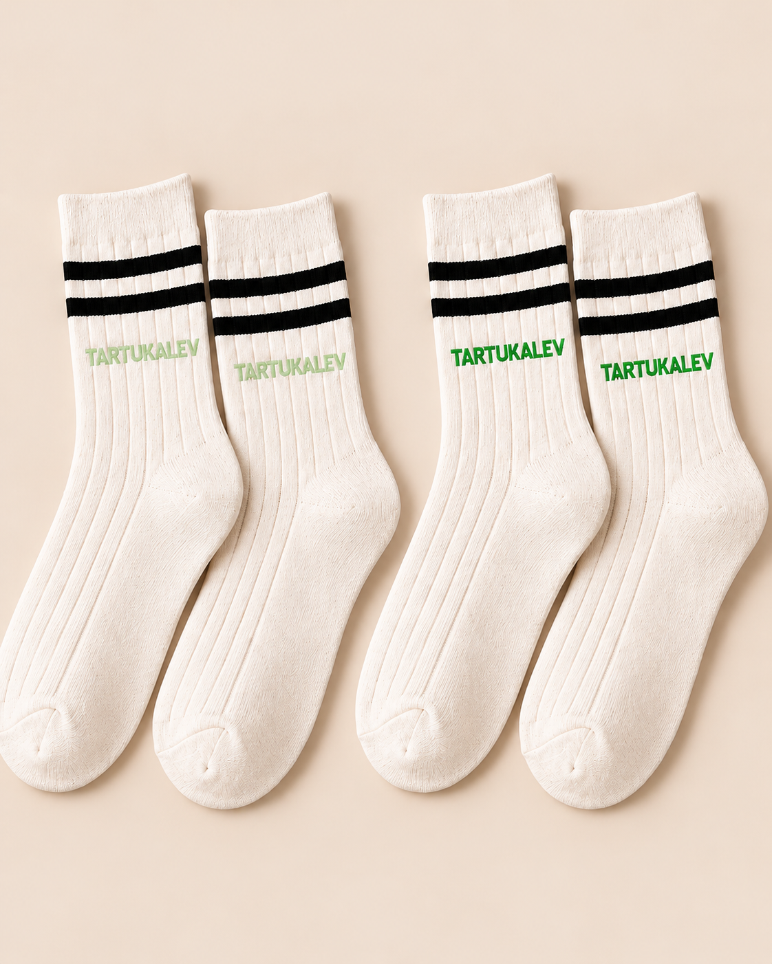 Cream crew sock sample comparison showing low-contrast and clearer green logo treatments