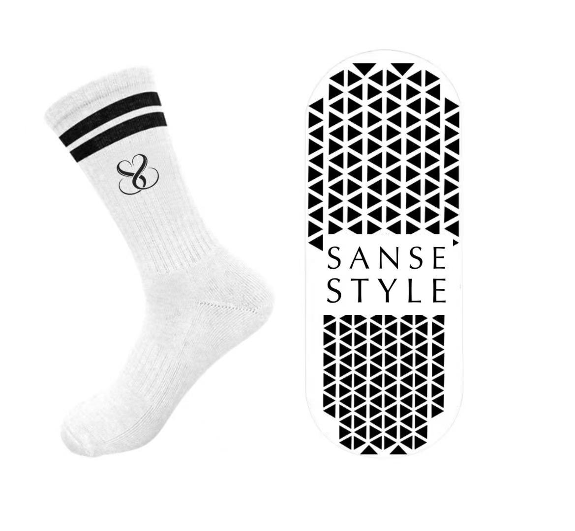 Initial white crew sock design showing logo and sole grip artwork