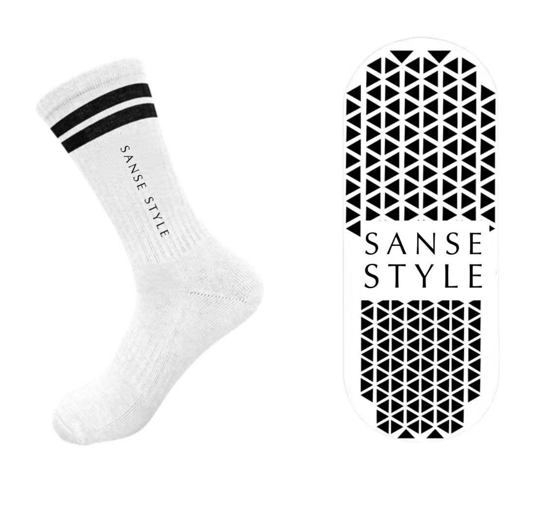 Alternative white crew sock concept with vertical brand name and grip artwork