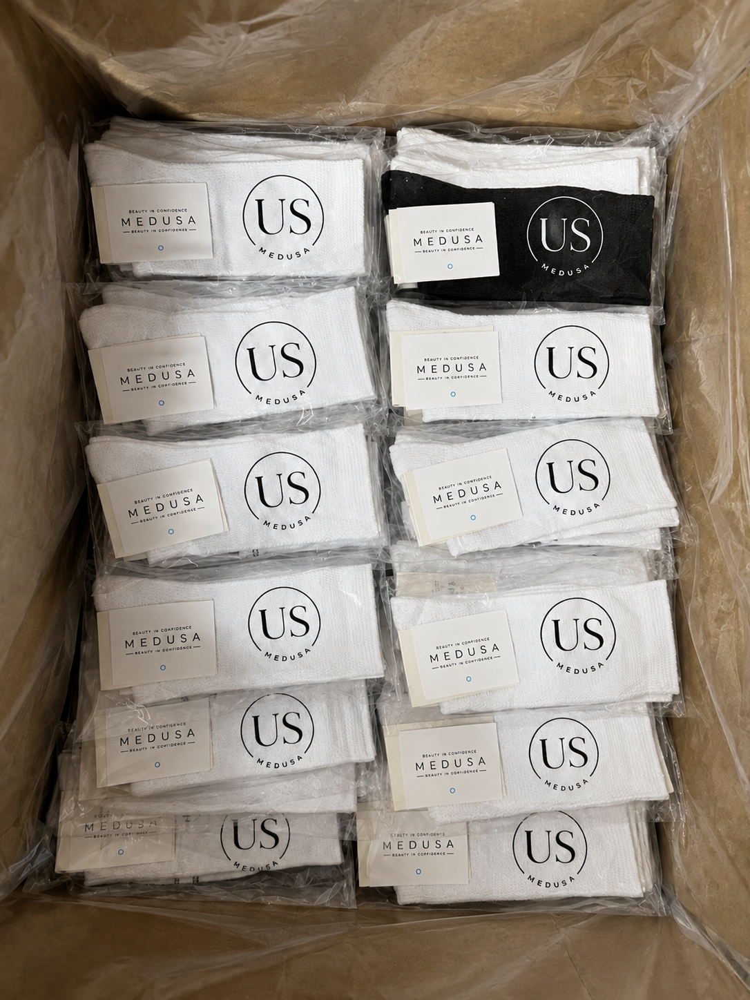 Individually packed US MEDUSA socks arranged inside a shipping carton