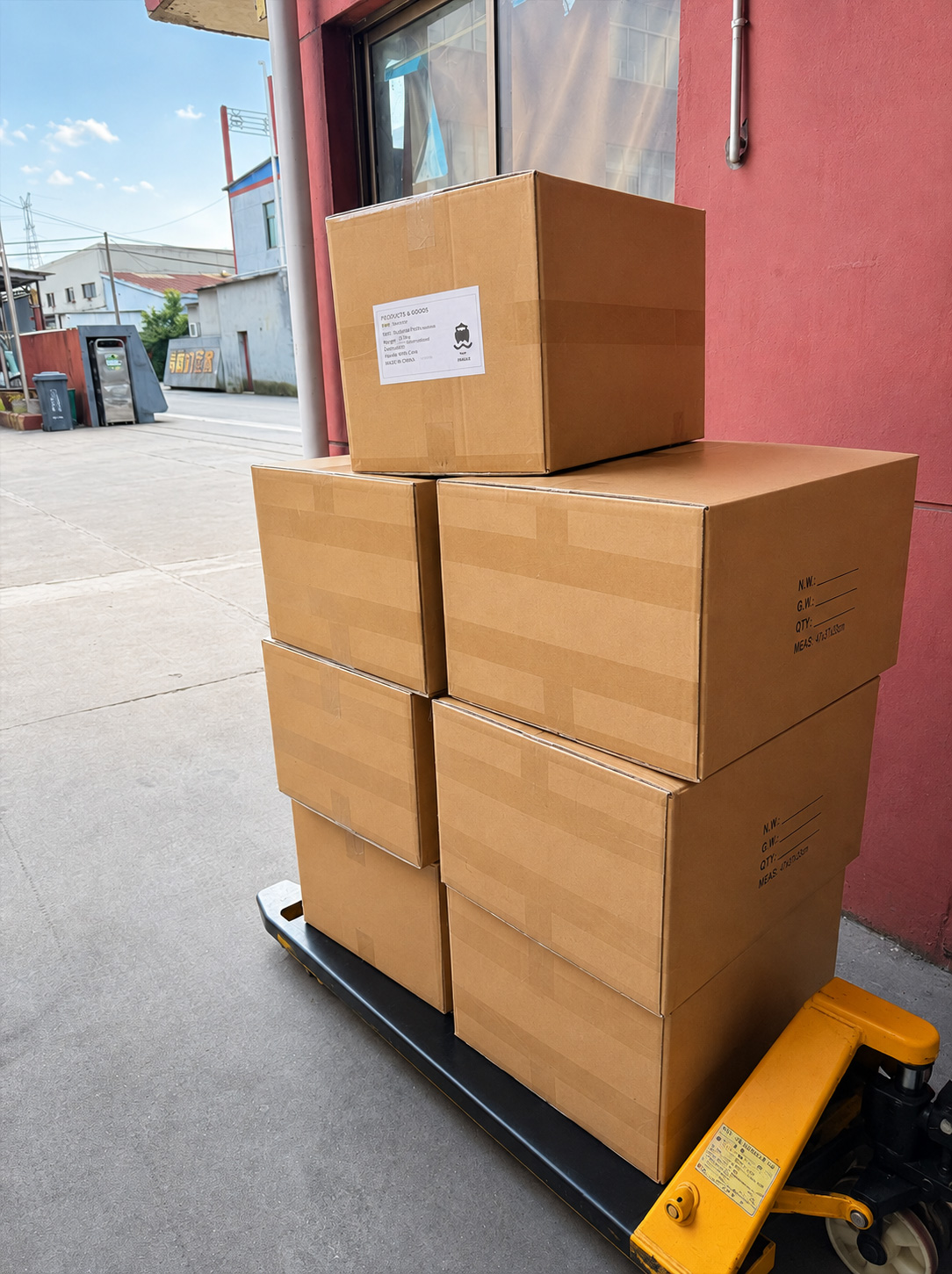 Sealed cartons for the crew sock order stacked on a pallet jack